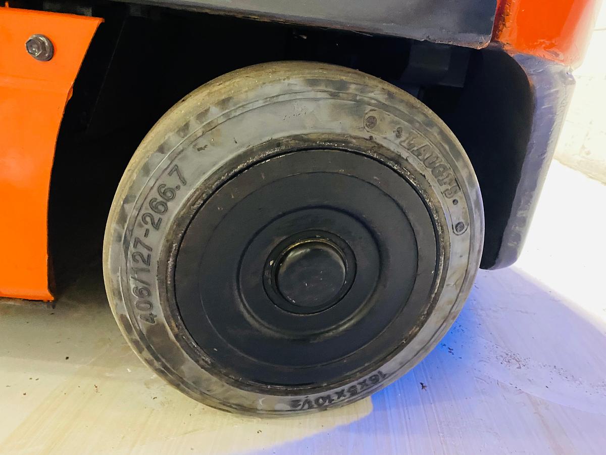 Left cushion steer tire showing wheel hub and CSA spec