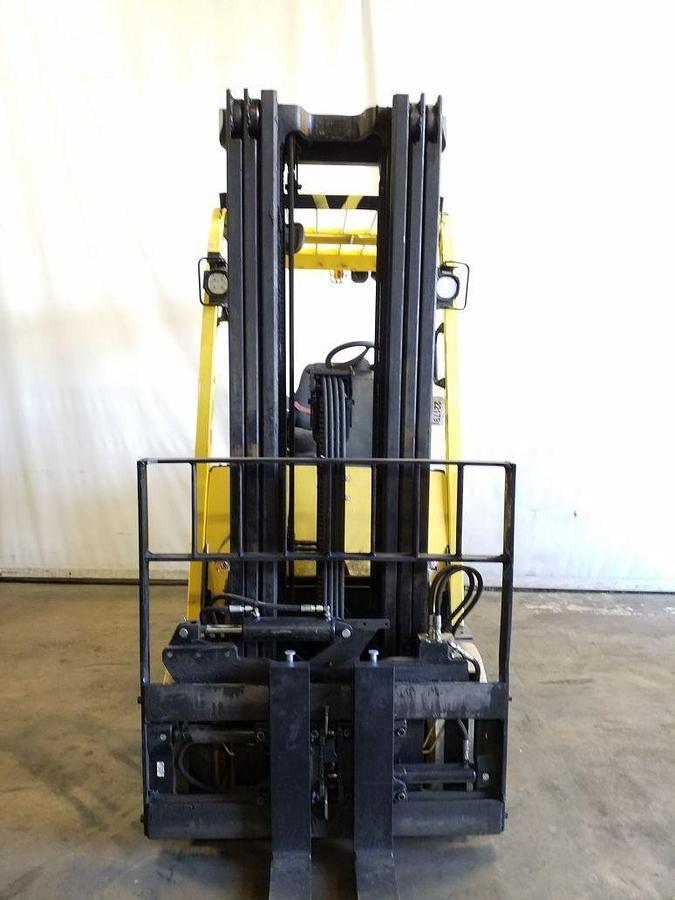 Front view of refurbished 2015 Hyster E70XN electric forklift showing 54" forks, side shift fork positioner, solid tires, and CSA certification decal during Ontario deployment.