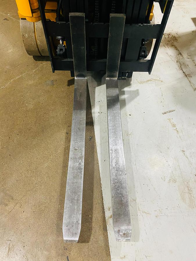 Side angled view of forks on Drexel SLT30 electric swing mast forklift showing 42” tips, load backrest, and CSA-certified mast – unit staged in Brampton ON