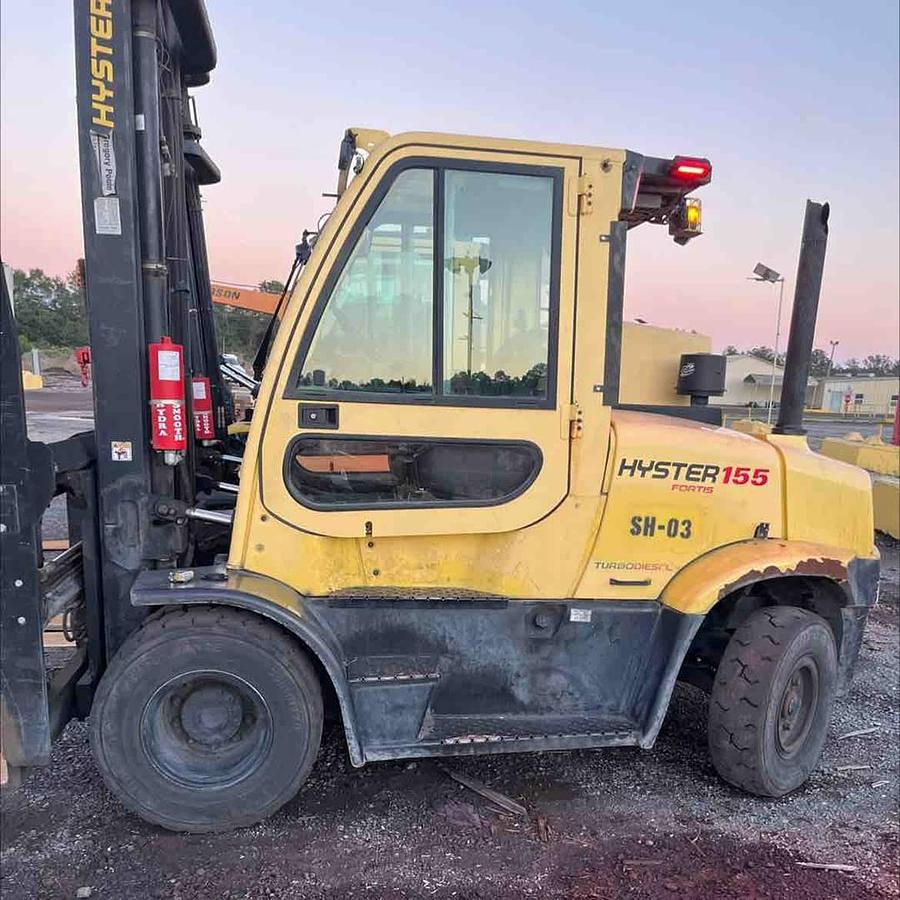 Side view of Hyster H155FT diesel pneumatic forklift – CSA-certified 15,500 lb chassis with 213” two-stage mast, fork positioner, and solid pneumatic tires shown refurbished and sold chassis-only – safety-tagged in Brampton ON – Premier Lift Equipment