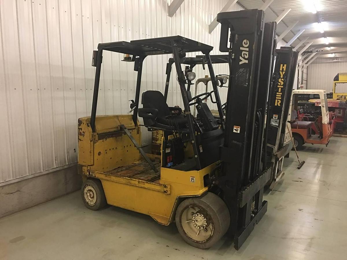 Side view of refurbished 2003 Yale ERC120HGN electric forklift showing operator cab, chassis, and triple mast during Brampton deployment