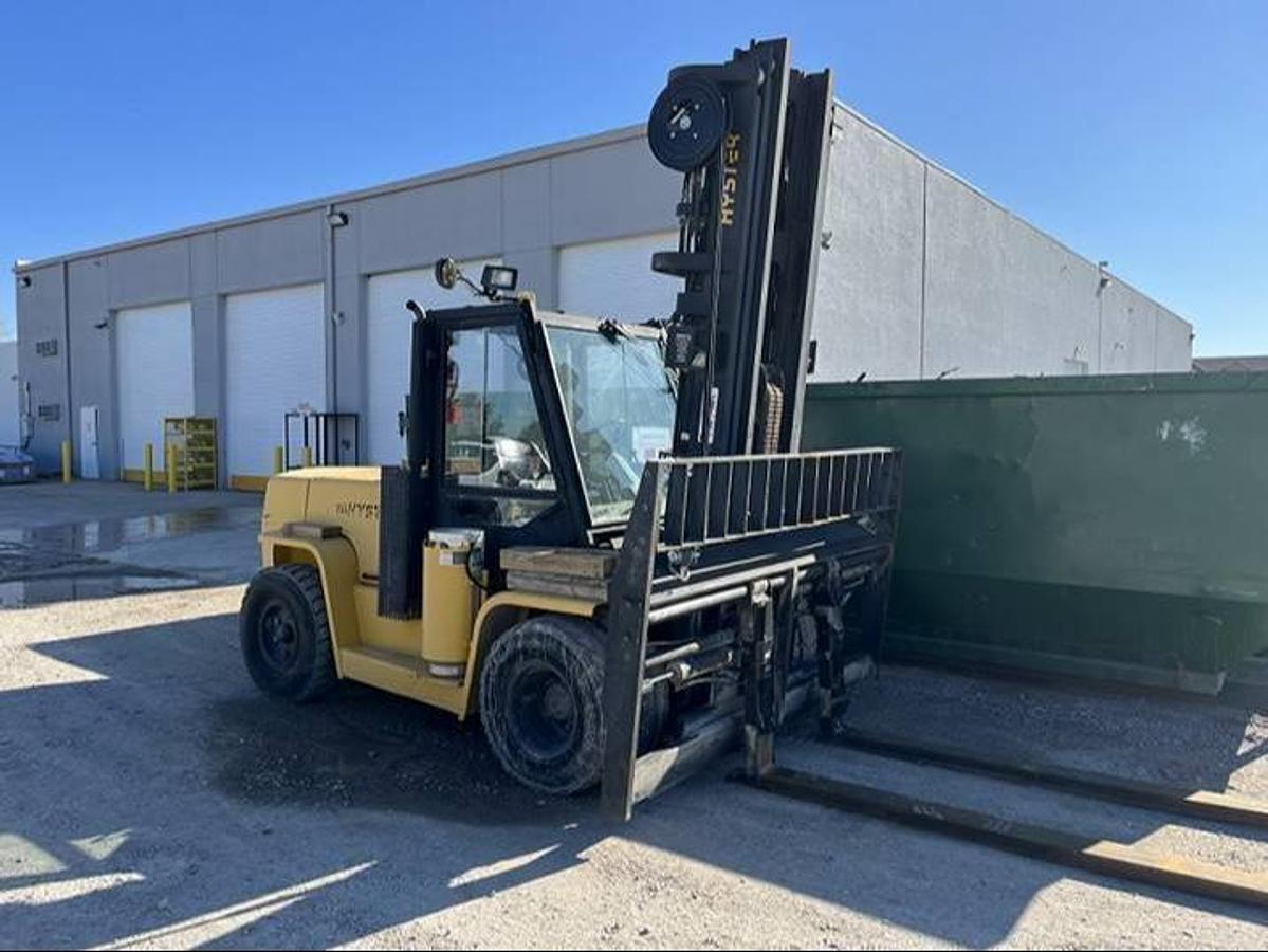 Side view of refurbished 2007 Hyster H155XL2 LP Gas forklift showing full cab, solid pneumatic tires, 96" forks, and CSA certification decal during Ontario deployment.
