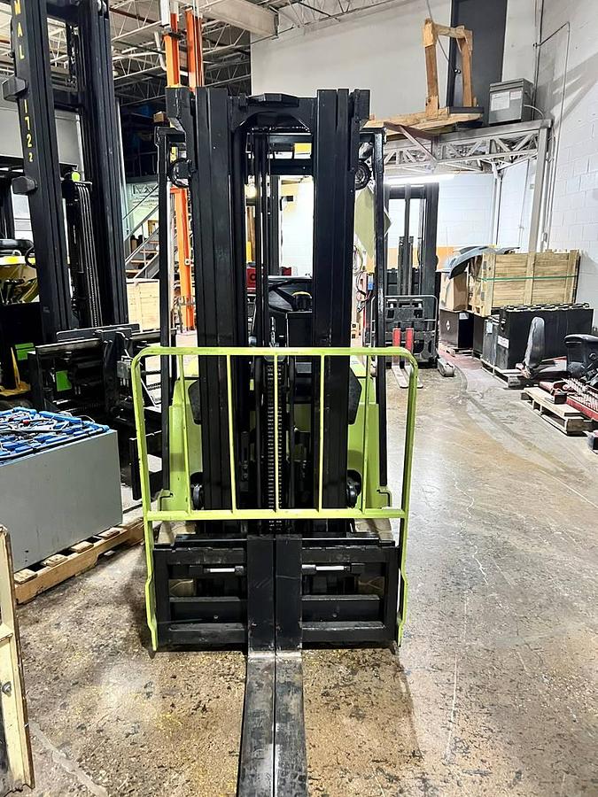 Front view of Clark TM15S electric sit-down forklift showing triple-stage mast, 42” forks, load backrest, and CSA-certified chassis – unit staged in Brampton ON