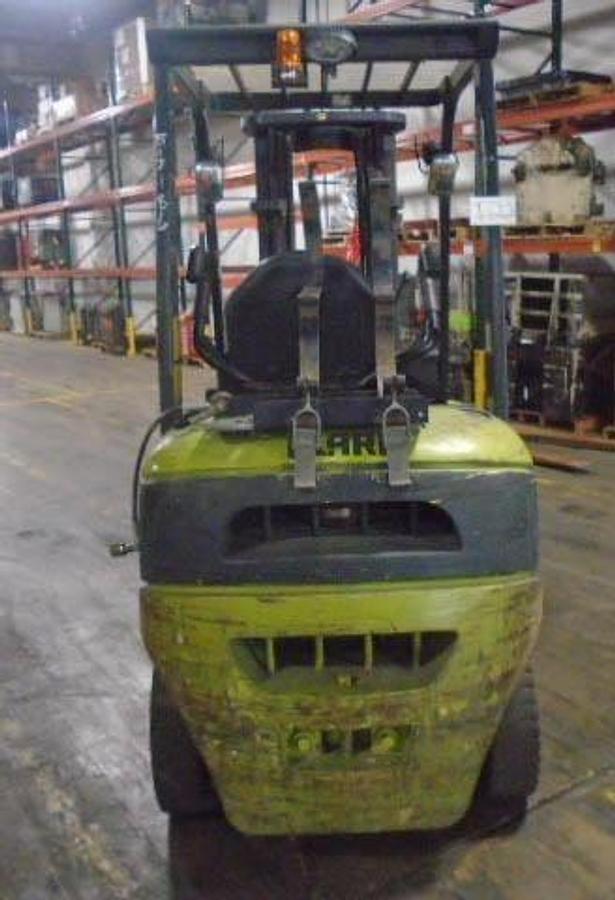 Back view of refurbished 2006 Clark C25L LPG forklift showing rear chassis, LPG tank, solid pneumatic tires, counterweight, and CSA certification decal during Brampton deployment.