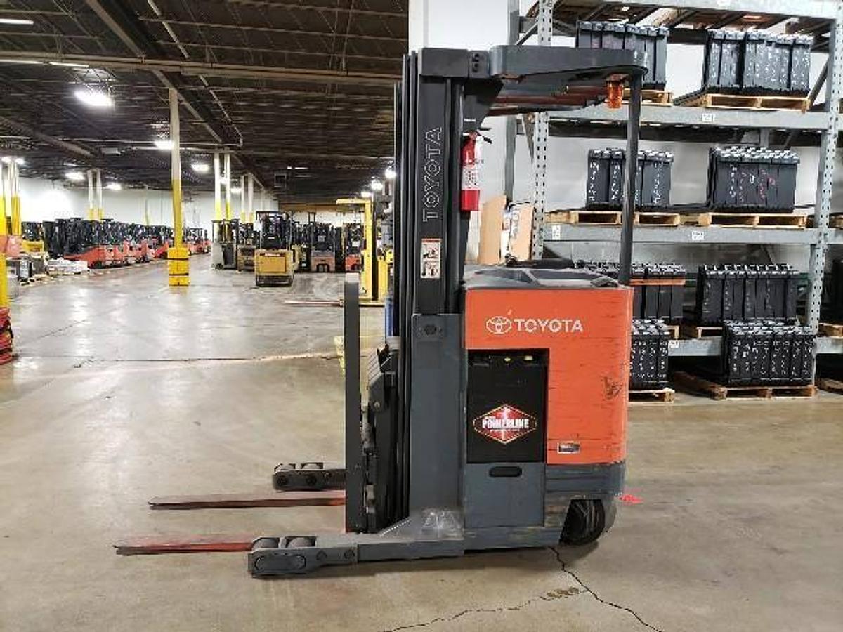 Opposite side view of refurbished 2008 Toyota 7BRU18 electric reach truck showing 36V battery box, hydraulic lines, and CSA decal during Ontario deployment
