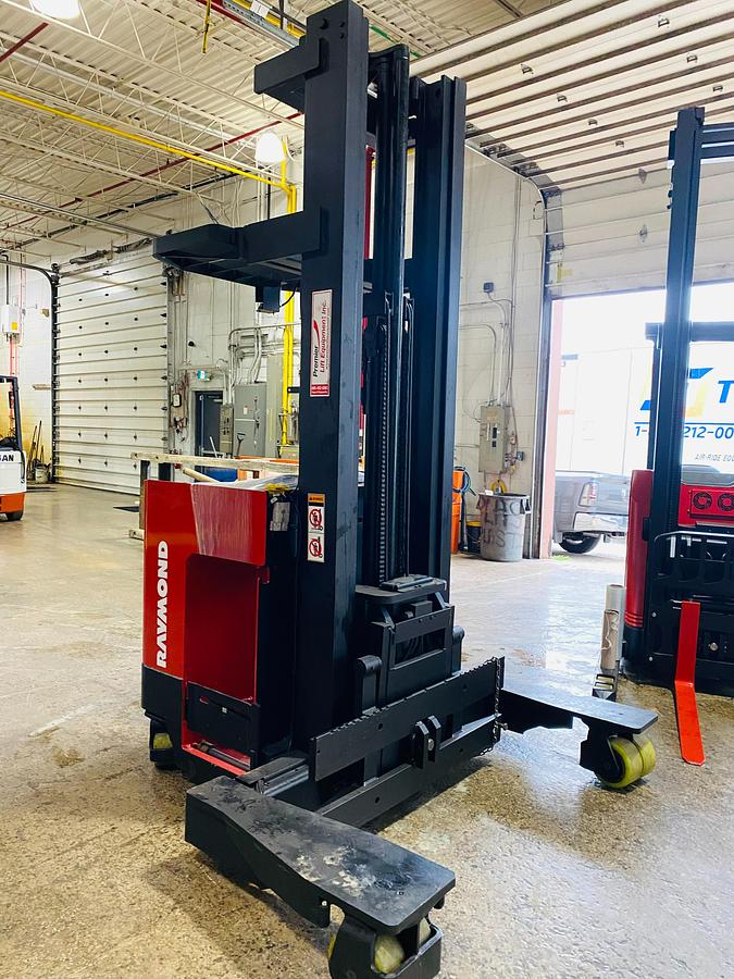 Refurbished 2001 Raymond EASI 4D-R45TT electric reach truck with 268" triple mast and CSA decals shown at front side angle during Brampton deployment