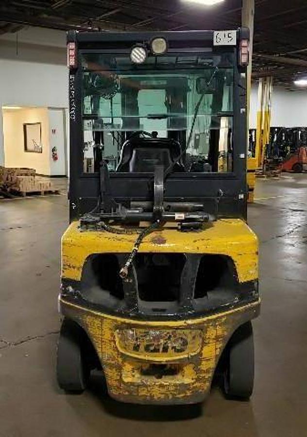 Rear view of refurbished 2014 Yale GLP050VX LPG pneumatic forklift showing counterweight, rear tires, and propane tank bracket during Brampton deployment