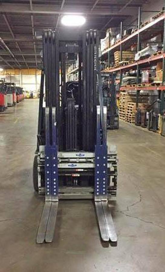 Front view of refurbished 2016 Toyota 8FBCHU25 electric 4-wheel sit-down forklift showing fork carriage, quad mast rails, and hydraulic tilt cylinders during Ontario deployment