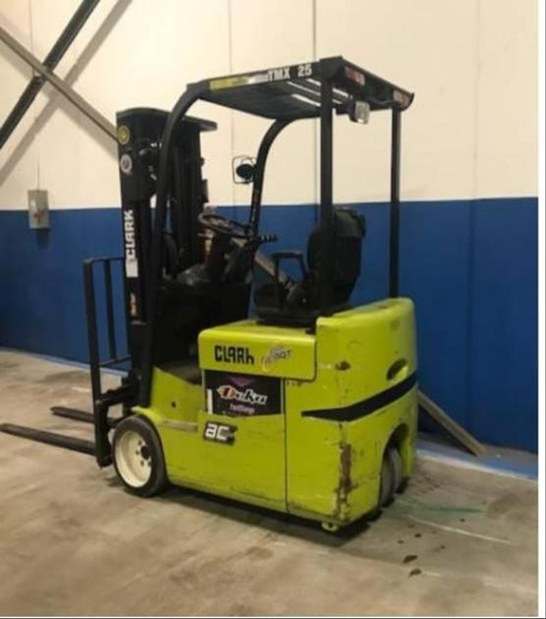 Angled back side view of Clark TMX25 electric sit-down forklift showing counterweight, rear tire configuration, and CSA-certified chassis – unit staged in Brampton ON