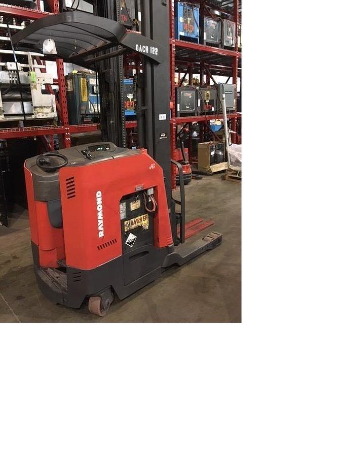 Rear-side angle of refurbished Raymond 750DR32TT electric deep-reach forklift standing upright, showing counterweight, rear wheels, operator compartment, and triple mast rails during Brampton deployment