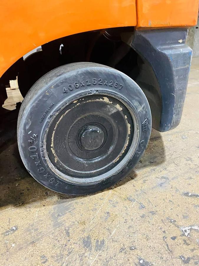 Smooth steer tire on refurbished Toyota LP gas forklift showing non-marking surface and indoor turning radius during Brampton deployment