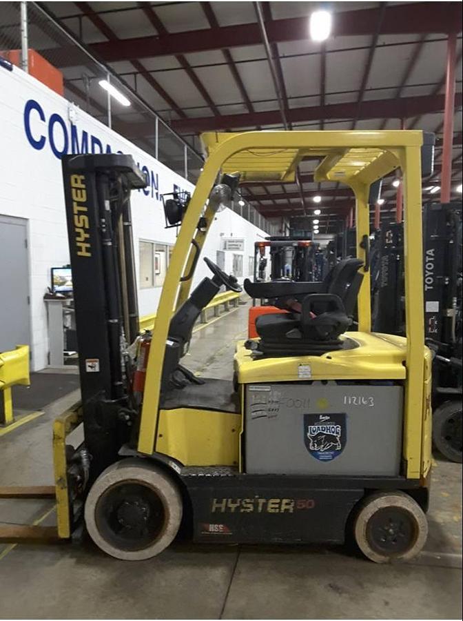 Opposite side view of refurbished 2013 Hyster E50XN electric forklift showing 2‑stage full free lift mast, 134" lift height, side shift, solid tires, and CSA certification decal during Ontario deployment.