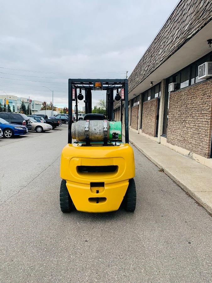 Rear view of Komatsu FG25T‑14 forklift showing counterweight, LP gas tank, and CSA certification decal during Brampton deployment