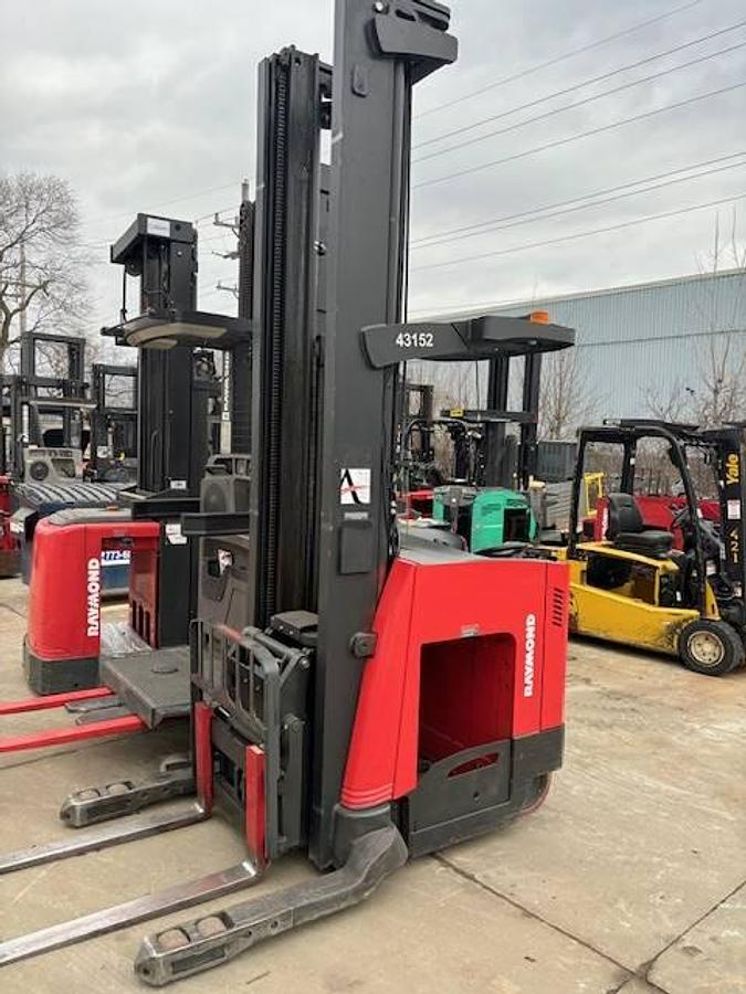 Front side angle of Raymond 750DR32TT deep-reach forklift showing 348" triple mast, reach carriage, directional wheels, and narrow aisle chassis during Brampton deployment