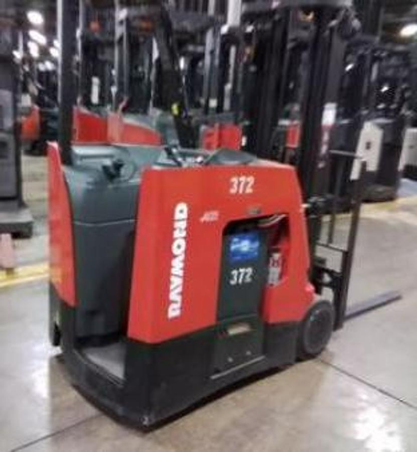 Rear angle view of Raymond 425-C35TT electric stand-up counterbalance forklift with battery installed – CSA-certified 3,500 lb chassis showing rear counterweight, operator compartment, and 203” triple mast staged in Brampton ON – Premier Lift Equipment