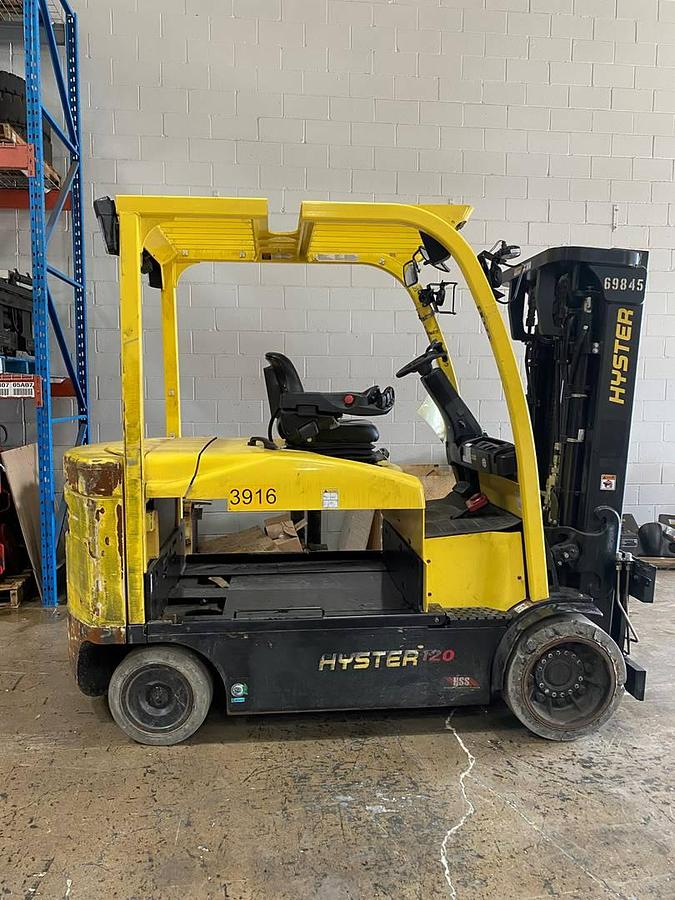 Side view of refurbished 2019 Hyster E120XN electric forklift showing 83"/169" triple mast, forks, solid tires, and CSA certification decal during Ontario deployment.