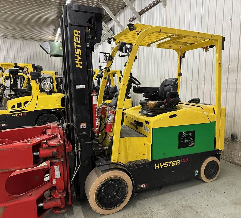 Front side view of refurbished 2020 Hyster E120XN electric forklift showing paper roll clamp, 100"/209" quad mast, non‑marking tires, and CSA certification decal during Ontario deployment.