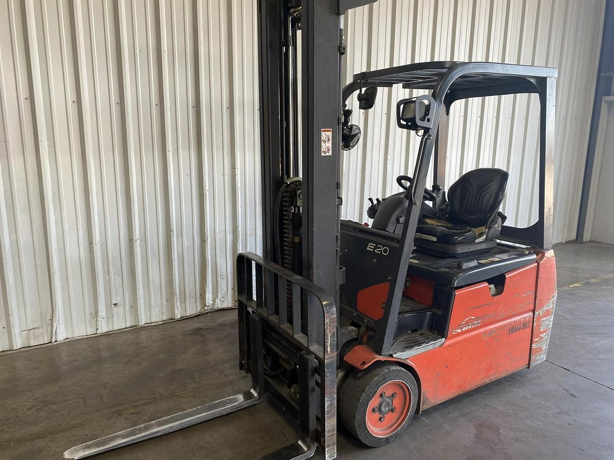 Front angled view of refurbished 2015 Linde E20 3‑wheel electric forklift showing 42" forks, solid cushion tires, 188" lift, battery compartment, and CSA certification decal during Brampton deployment.