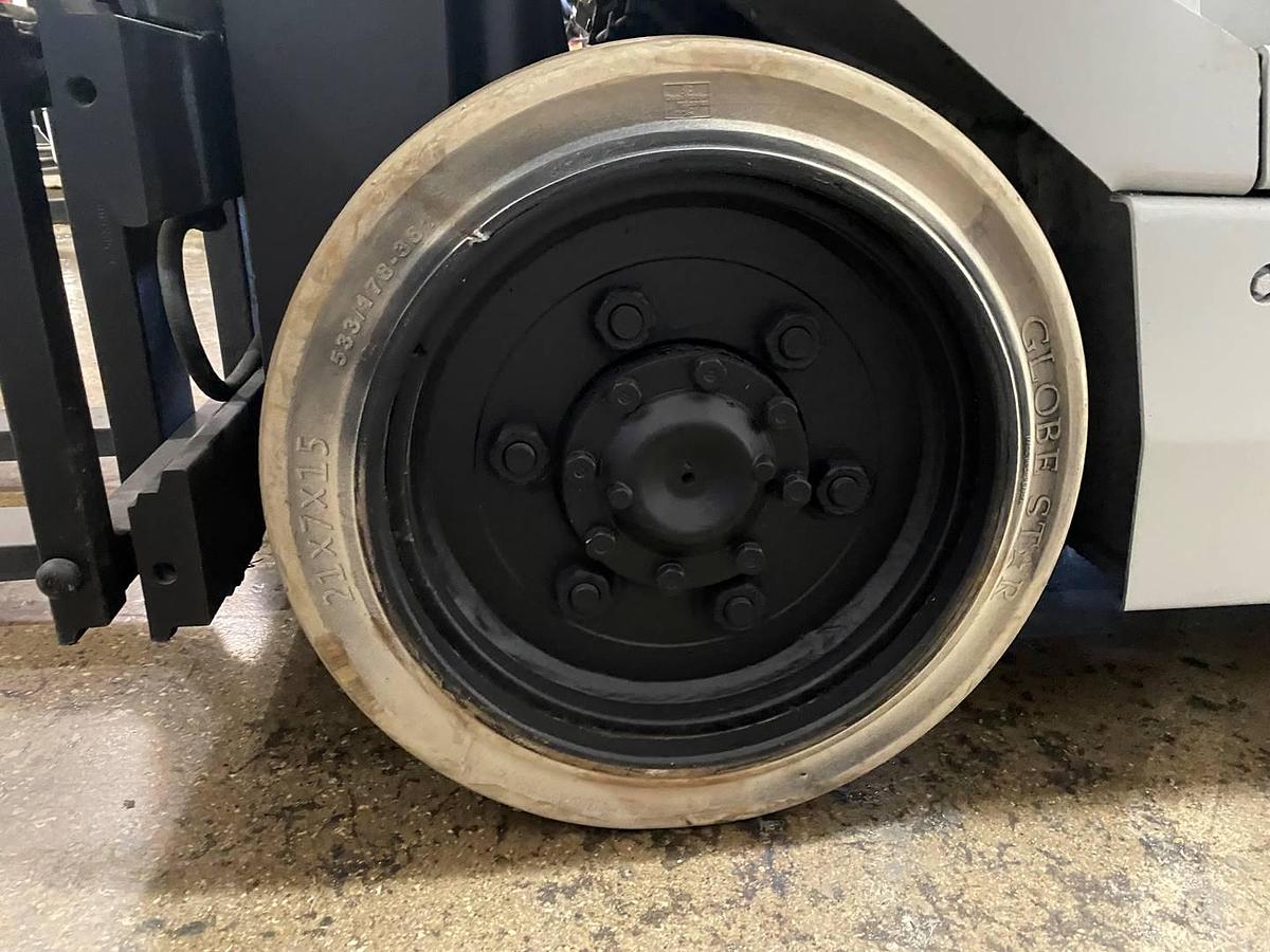 Left cushion drive tire showing wheel hub and CSA spec