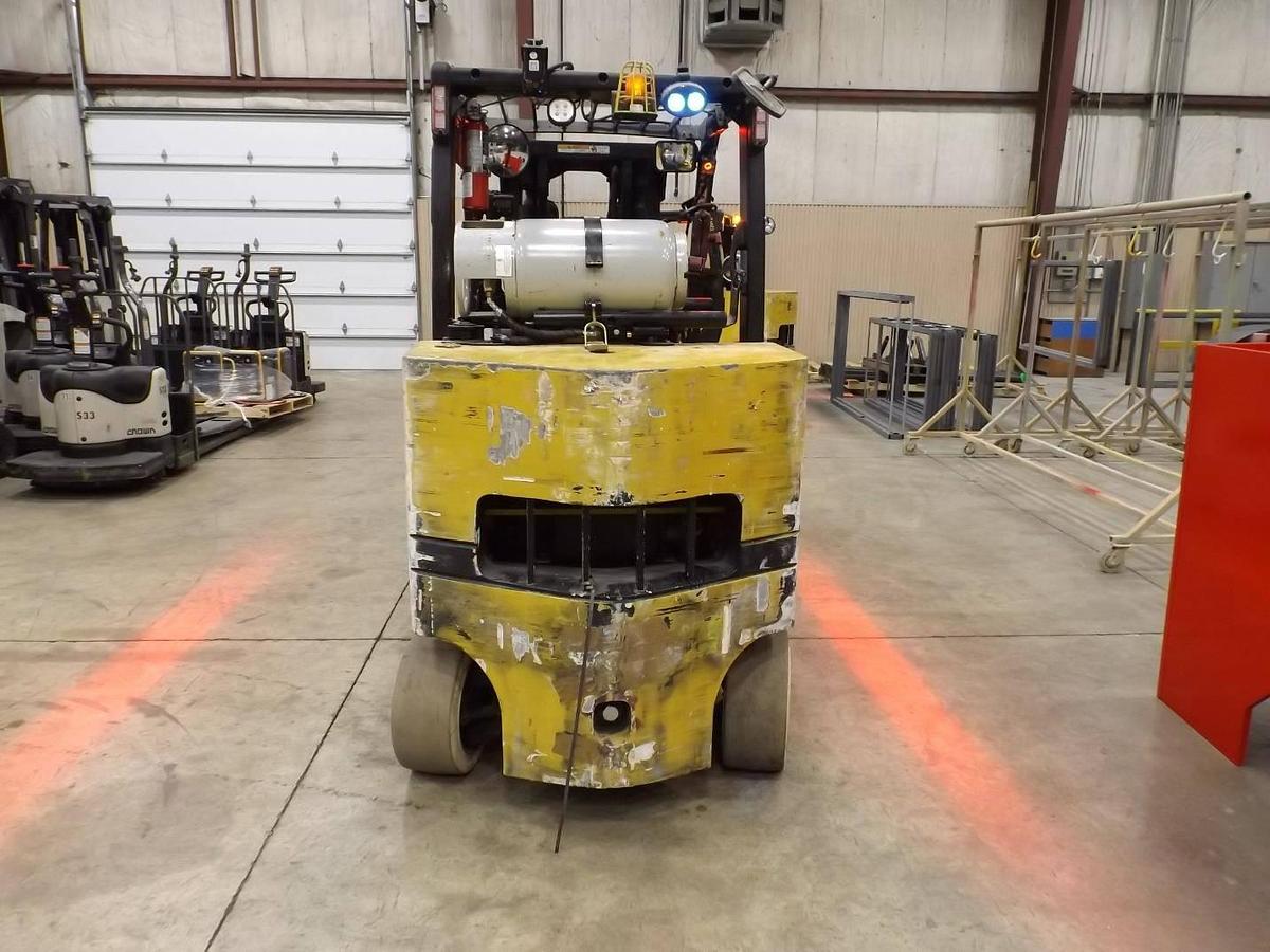 Rear view of Yale GLC120VX operator compartment showing ergonomic seat, steering column, and overhead guard – CSA certified forklift