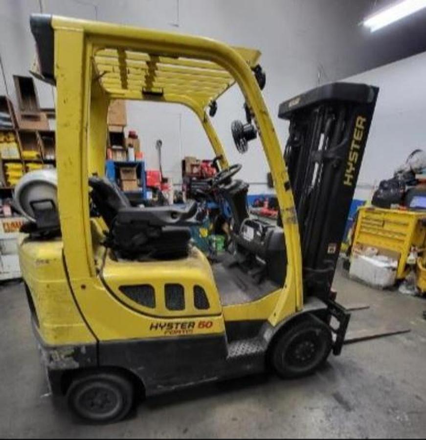 Side view of 2018 Hyster S50FT propane cushion tire forklift – CSA-certified 5,000 lb chassis with 127” low-profile mast, integral fork positioner and side shift attachment, clamp-ready 4-way hydraulics, and solid cushion tires shown refurbished and sold chassis-only – safety-tagged in Brampton ON – Premier Lift Equipment