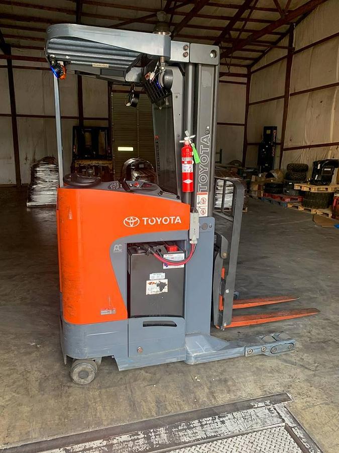 Side view of refurbished 2011 Toyota 8BRU18 electric reach truck showing mast rails, CSA decal, and side shift carriage during Ontario deployment
