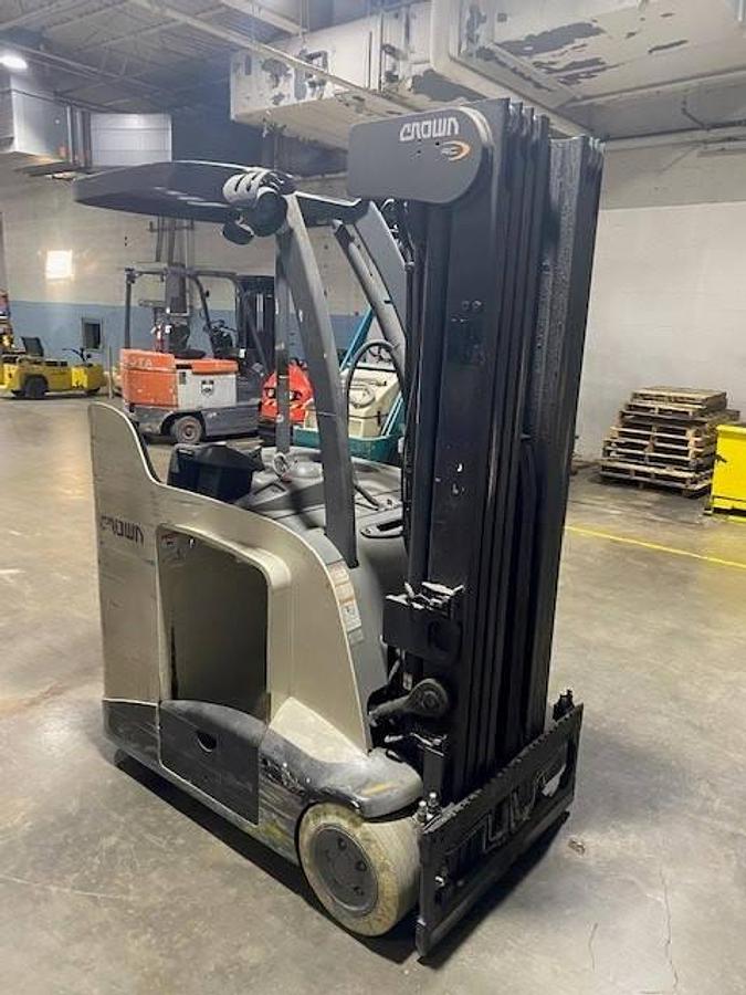 Front angled view of refurbished 2017 Crown RC5545‑40 electric forklift showing 42" forks, 260" quad mast, side shift, 36 volt battery compartment, and CSA certification decal during Ontario deployment.
