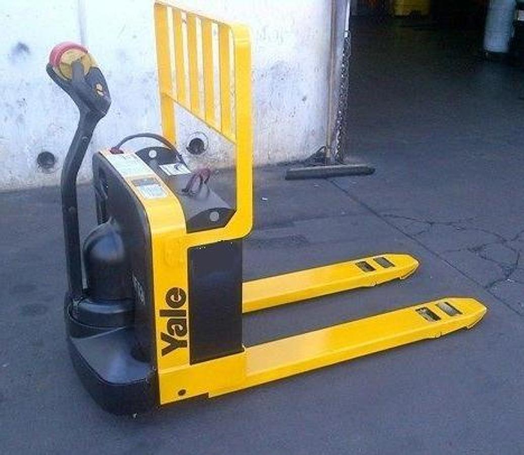 Rear angle side view of refurbished 2014 Yale MP040 electric walkie pallet jack showing operator handle, battery pack, and built-in charger during Ontario deployment