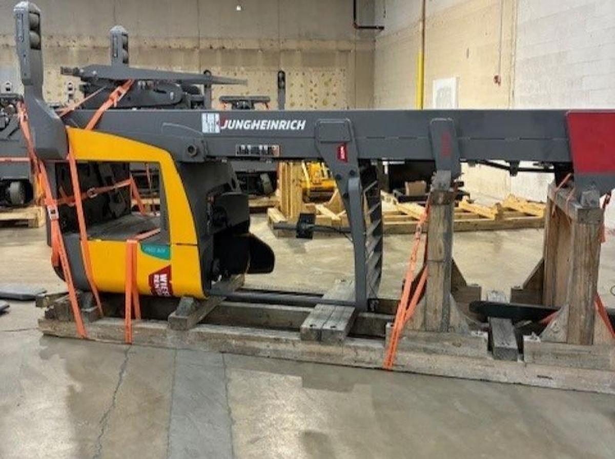 2019 Jungheinrich ETR335D reach truck laid down and cradled on its side with 36V battery removed, showing chassis, mast assembly, and TSU structure.