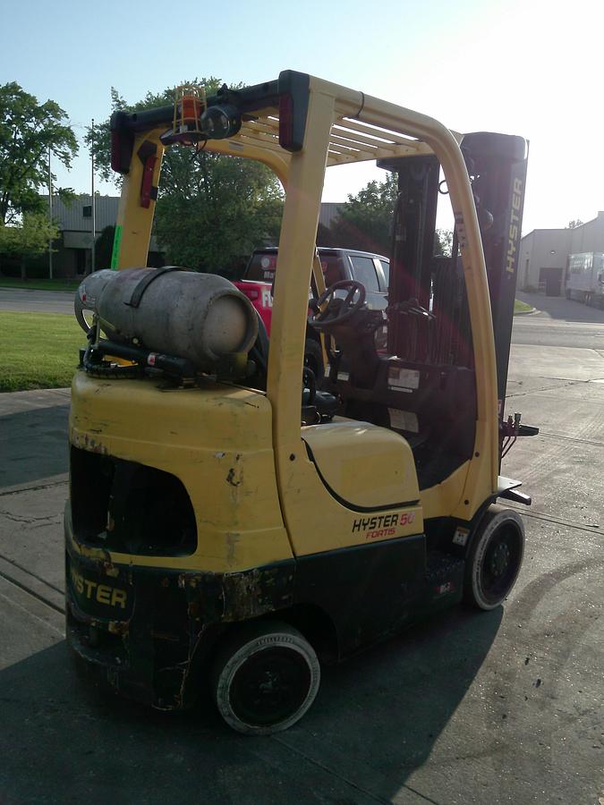Rear‑angle view of a 2019 Hyster S50FT LPG cushion forklift showing counterweight, chassis, and indoor‑warehouse cushion‑tire configuration