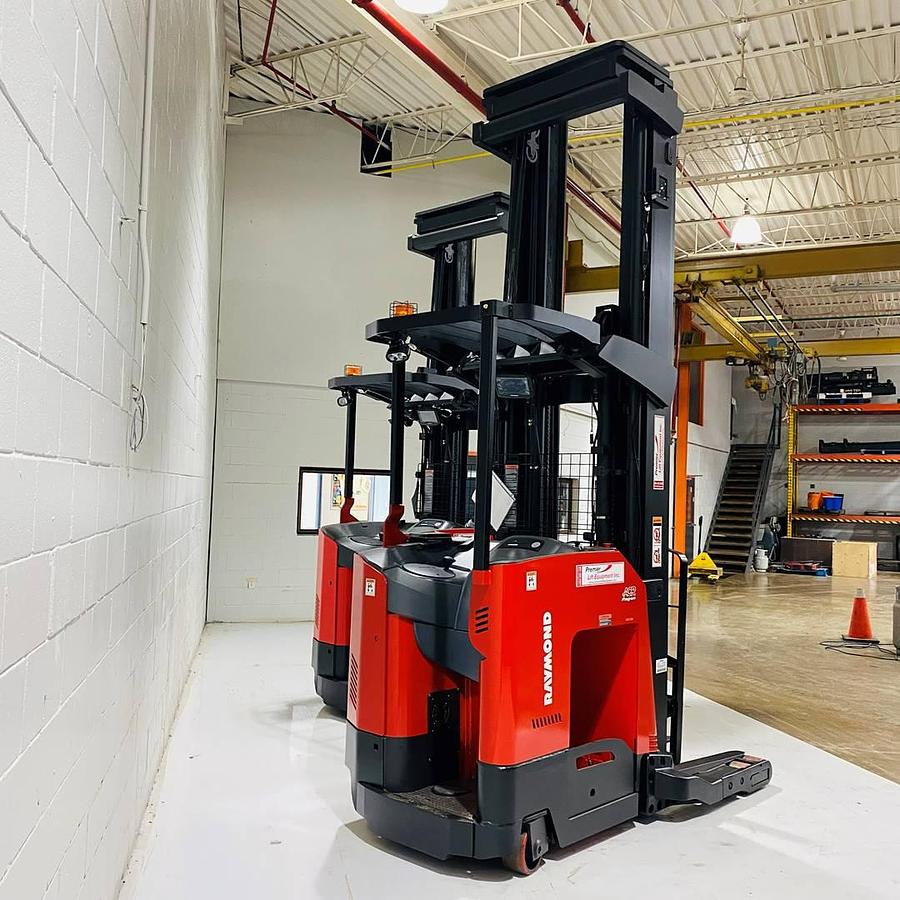 Narrow‑aisle freezer reach truck showing freezer‑grade poly tires and mast height