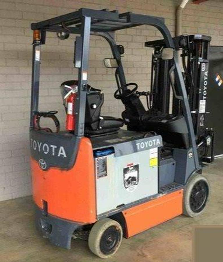 Rear angle side view of refurbished 2015 Toyota 8FBCHU25 electric 4-wheel sit-down forklift showing operator seat, counterweight, and rear tires during Ontario deployment