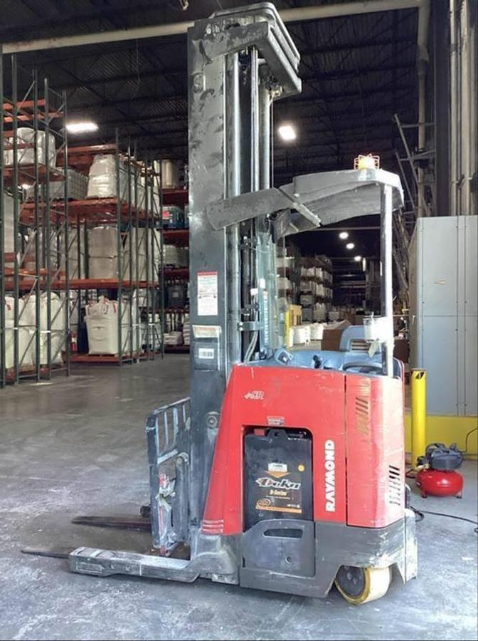 Side profile of Raymond 750DR32TT electric deep-reach forklift showing extended mast rails, reach mechanism, and chassis layout during Brampton deployment