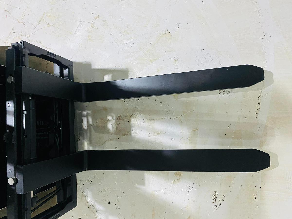 Downward view of forks on Toyota 8FBCU20 COM electric sit-down forklift showing 42” tips, load backrest, and CSA-certified carriage – unit staged in Brampton ON