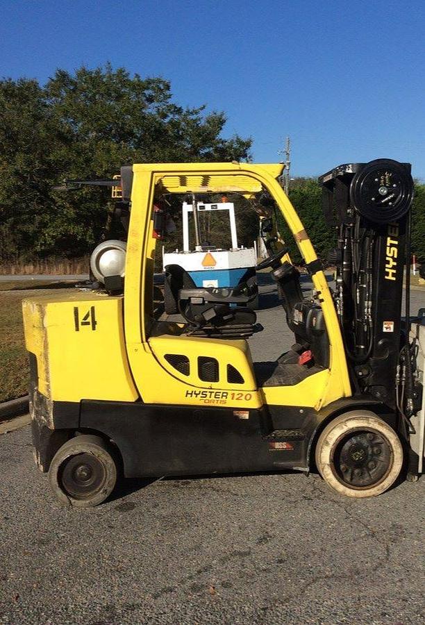 Opposite side profile of refurbished 2013 Hyster S120FT LPG cushion forklift showing 3-stage mast, 4-way hydraulic carriage, chassis layout, and indoor tires during Brampton deployment