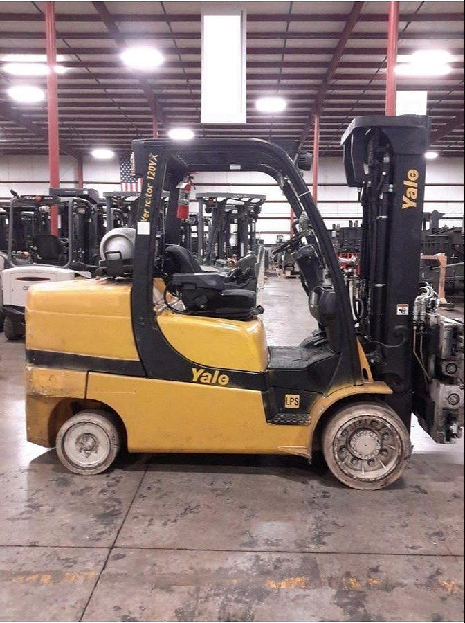 Side profile of 2011 Yale GLC100VX LPG cushion forklift showing mast rails, chassis layout, and cushion tires during Brampton deployment
