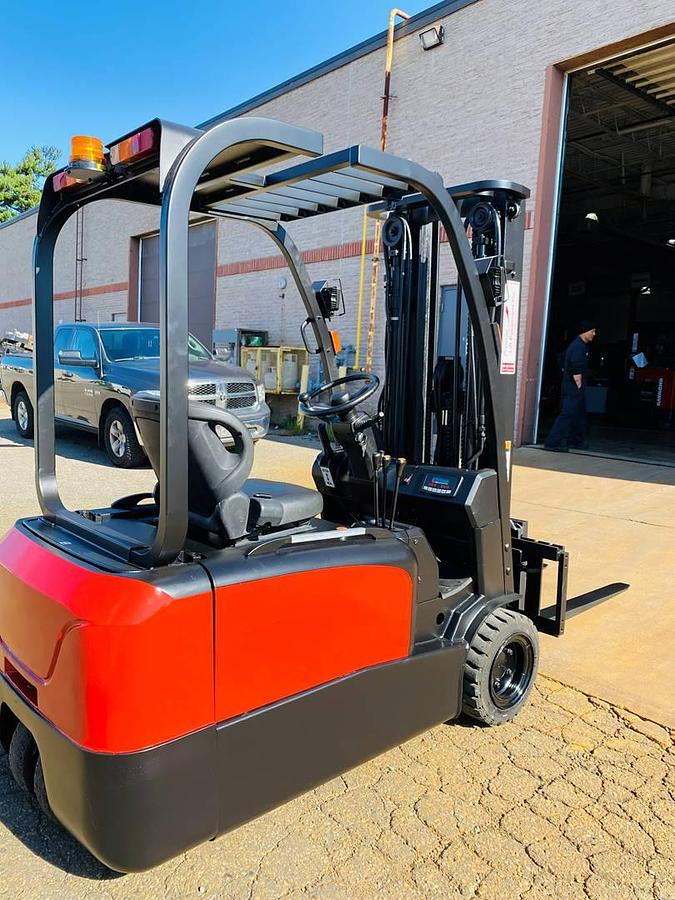 Rear opposite side view of refurbished 2018 EP Equipment CPD20 3‑wheel electric forklift showing operator compartment, rear chassis, solid pneumatic tires, battery compartment, and CSA certification decal during Brampton deployment.