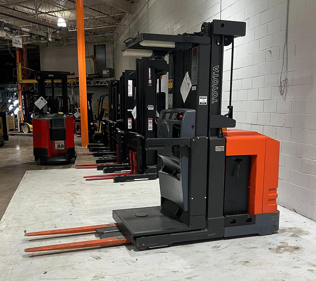 Opposite side view of forklift — battery compartment, mast rails, and chassis detail
