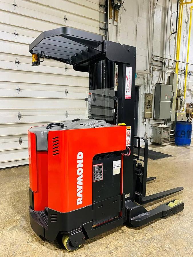 Close-up side view of vintage 1996 Raymond EASIR40TT electric reach truck showing chassis weldments, reach carriage, and battery enclosure during Concord deployment