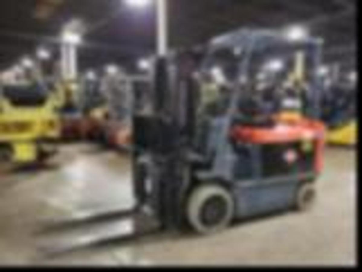 Side view of refurbished 2019 Toyota 7FBCU35 electric forklift showing triple mast, forks, and CSA certification decal during Brampton deployment