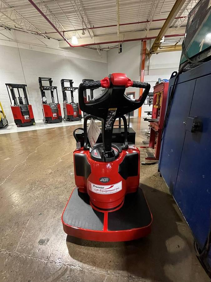 Rear view of refurbished 2014 Raymond 8410 electric rider pallet truck showing fixed operator platform, control head, and rear chassis weldments during Toronto deployment
