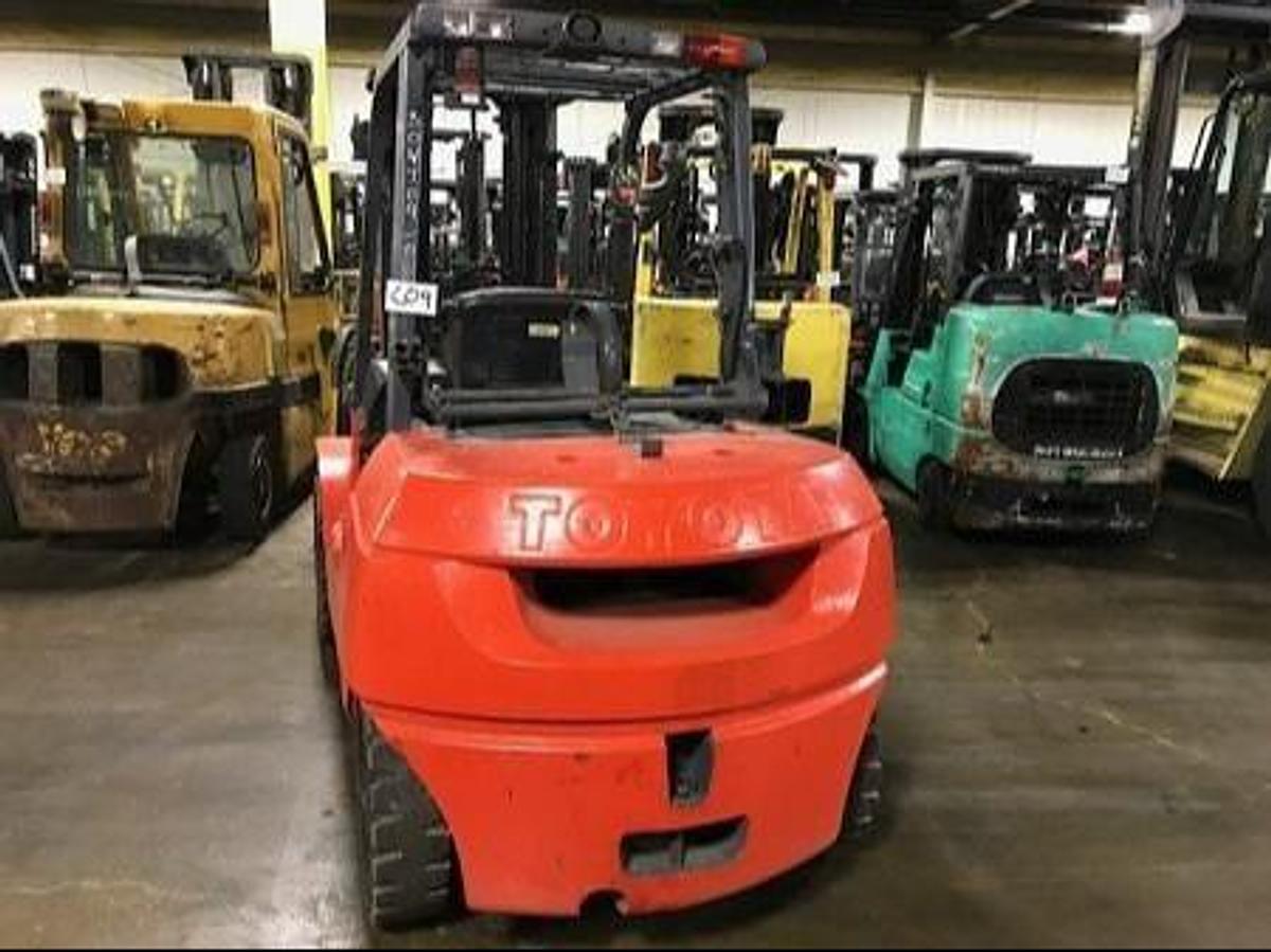 Back view of refurbished 2008 Toyota 7FGU35 LP gas forklift showing counterweight, propane tank mount, and CSA inspection tag during Brampton deployment