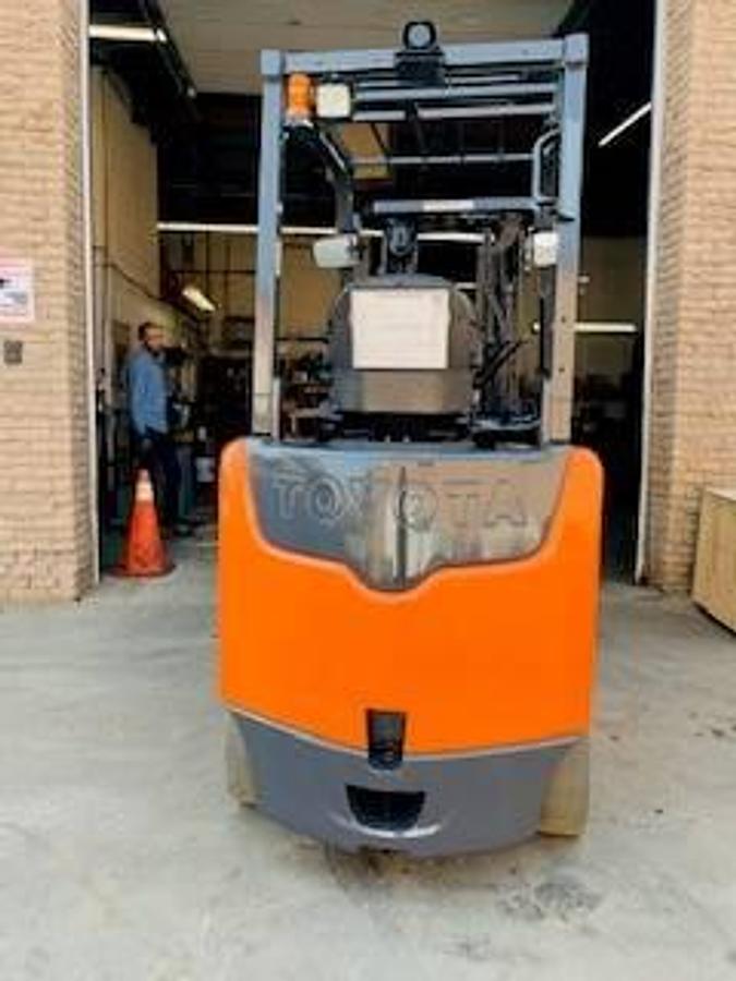Rear view of Toyota 8FBCU30 electric forklift highlighting counterweight, safety decals, and CSA certification during warehouse deployment