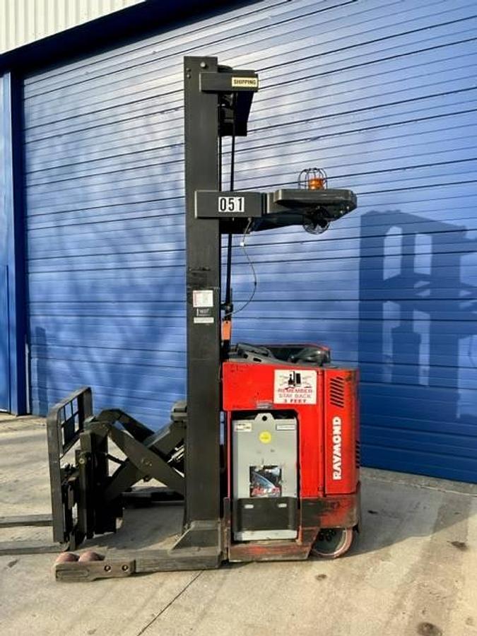 Side view of refurbished 2014 Raymond EASI-R40TT electric reach truck showing battery compartment, chassis frame, and reach carriage during Vaughan deployment