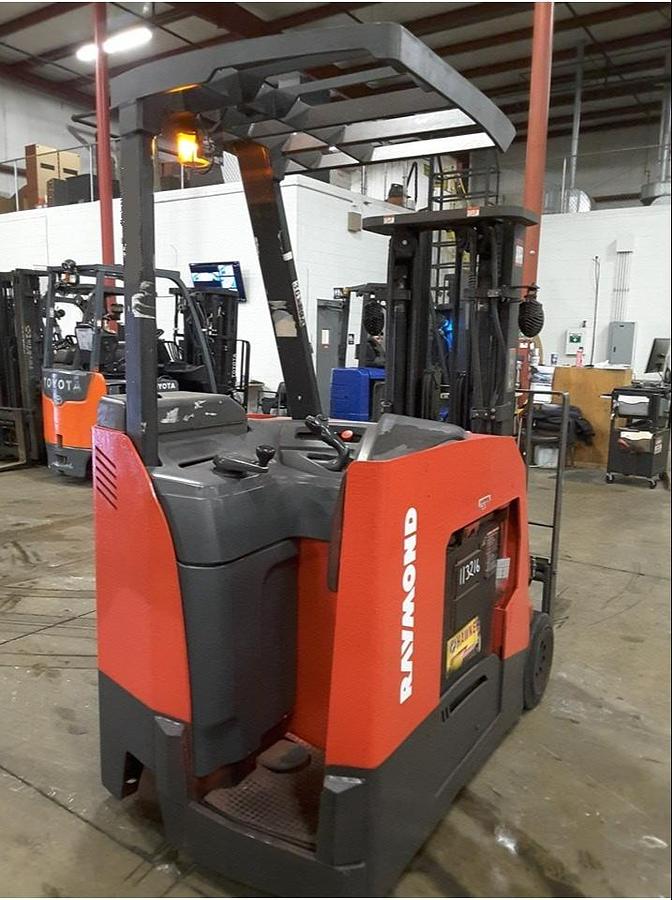 Interior view of refurbished 2011 Raymond 425-C50TT electric docker showing operator controls, floor mat, safety rails, and CSA decals during Concord deployment