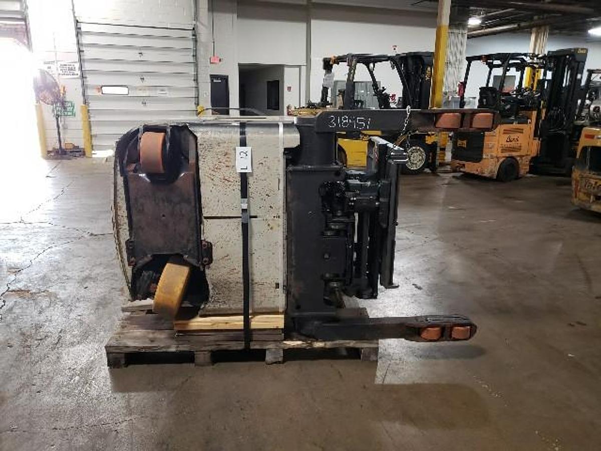 Underside chassis of 2021 Crown RMD6025-32 Reach Truck | Crated for export | Frame, steer axle, and battery tray visible | CSA Certified | Brampton ON
