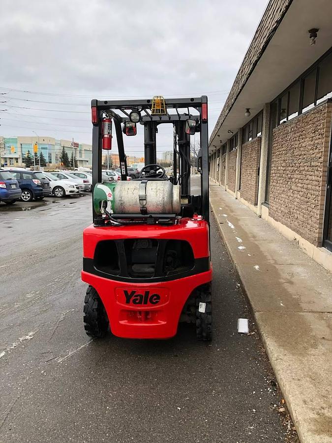 Back view of refurbished 2011 Yale GLP050VX LP Gas forklift showing counterweight, rear chassis, solid pneumatic tires, propane tank mount, and CSA certification decal during Ontario deployment.