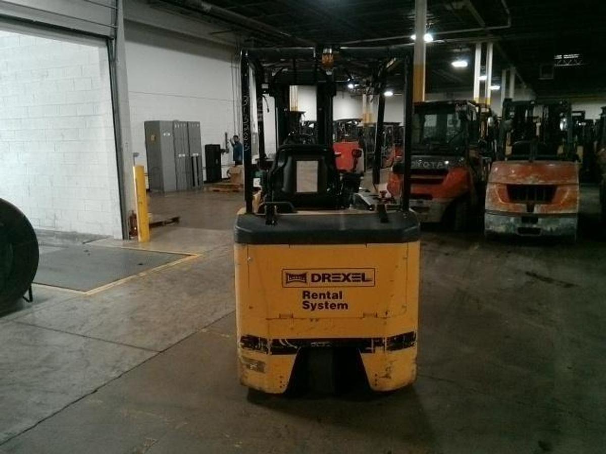 Rear side angle of Drexel SLT30AC SwingMast forklift showing counterweight, rear wheels, and CSA certification during warehouse deployment