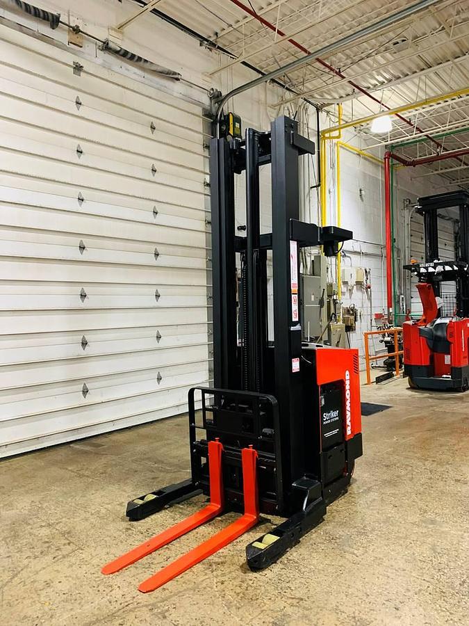 Front angle view of refurbished 2000 Raymond EASIR40TT electric reach truck showing mast, forks, side shift carriage, and CSA inspection tag in Mississauga inventory