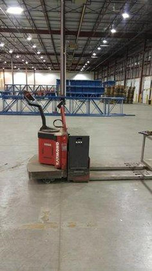 Side view of refurbished 1996 Raymond 112-FRE60L electric walkie/rider pallet jack showing rider platform, tiller arm, and 27" x 48" forks during Ontario deployment